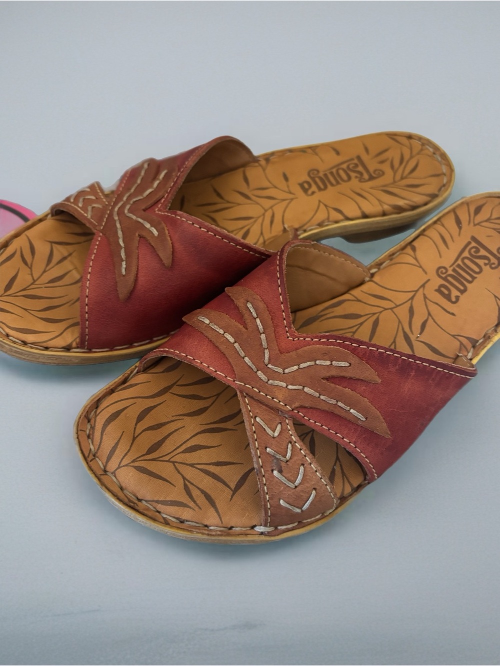 Tsonga leather artisans sandals featuring a red floral pattern.